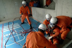 貨物船の船底で動けなくなった作業員を想定して行われた合同救助訓練＝14日、市消防本部