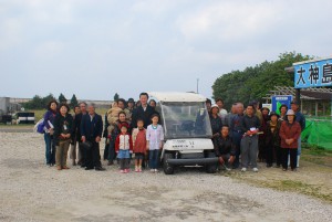 子どもたちの後ろに立つ長尾さん感謝し、全員で記念撮影した＝16日、大神島漁港
