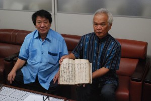 砂川昌之さん（右）が系図家譜を所蔵し、砂川玄正さんに翻刻を依頼していた＝１９日、宮古テレビ
