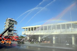 色とりどりの水による一斉放水が行われ、１年間の無災害を願った＝７日、市消防本部