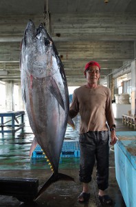 １２２㌔の本マグロを釣り上げた松原さん。昨年は３００㌔超を釣り上げた＝９日、荷川取漁港