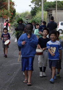 パーントゥの面をかぶった子供を先頭に子供や女性たちが集落を練り歩いた「野原のパーントゥ」＝１８日夕、上野野原集落