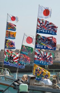 「旧正月」を祝い、晴天の下ではためく大漁旗＝８日、佐良浜漁港