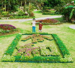 「令和」の花文字を前にした児童たち＝６日、市熱帯植物園