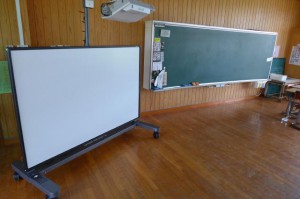 新たに導入された上部にプロジェクターを備えた電子黒板（手前左）と、従来の黒板（奥）＝30日、平良第一小学校