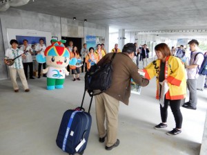 到着ゲート前では来島した台湾からの旅客に宮古島観光協会の職員らが記念品を配布した＝25日、下地島空港